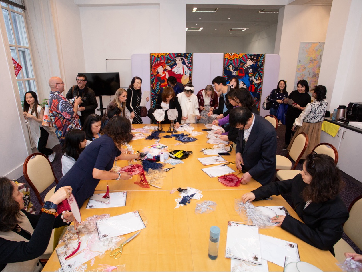 Visitors participate in a silk fan workshop at the London Craft Week.