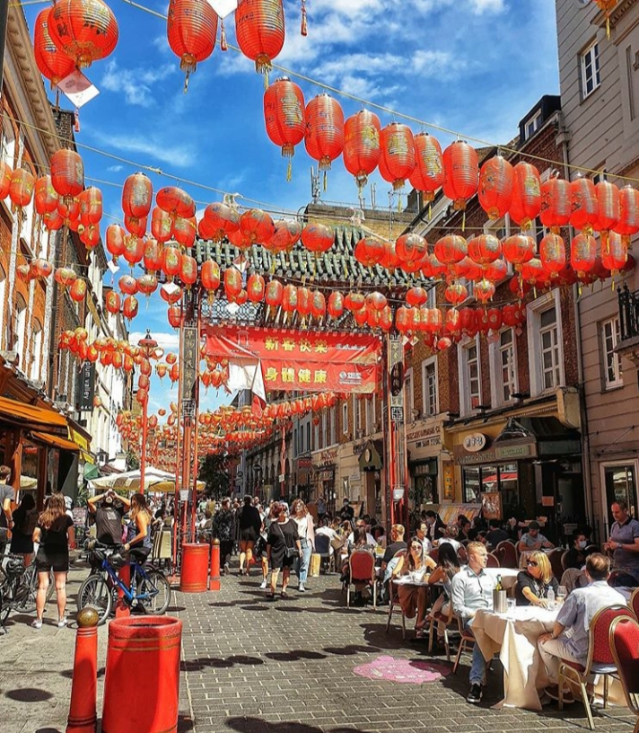 Customers are dining outside restaurants in London’s Chinatown.