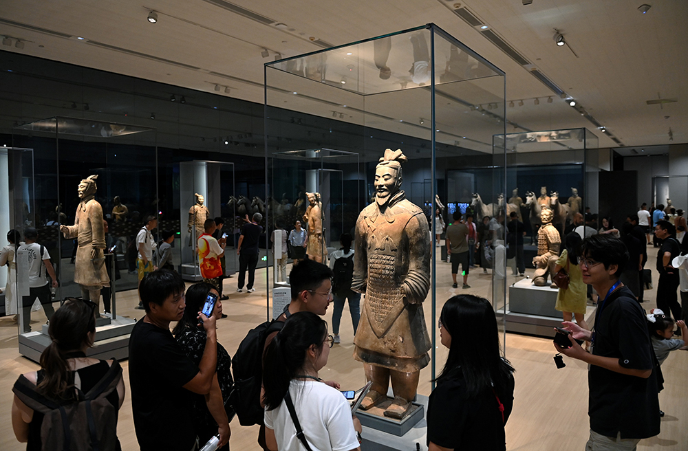 People visit an exhibition, commemorating the 50th anniversary of the discovery and excavation of the iconic Terracotta Warriors, at the Emperor Qinshihuang's Mausoleum Site Museum in Xi'an.