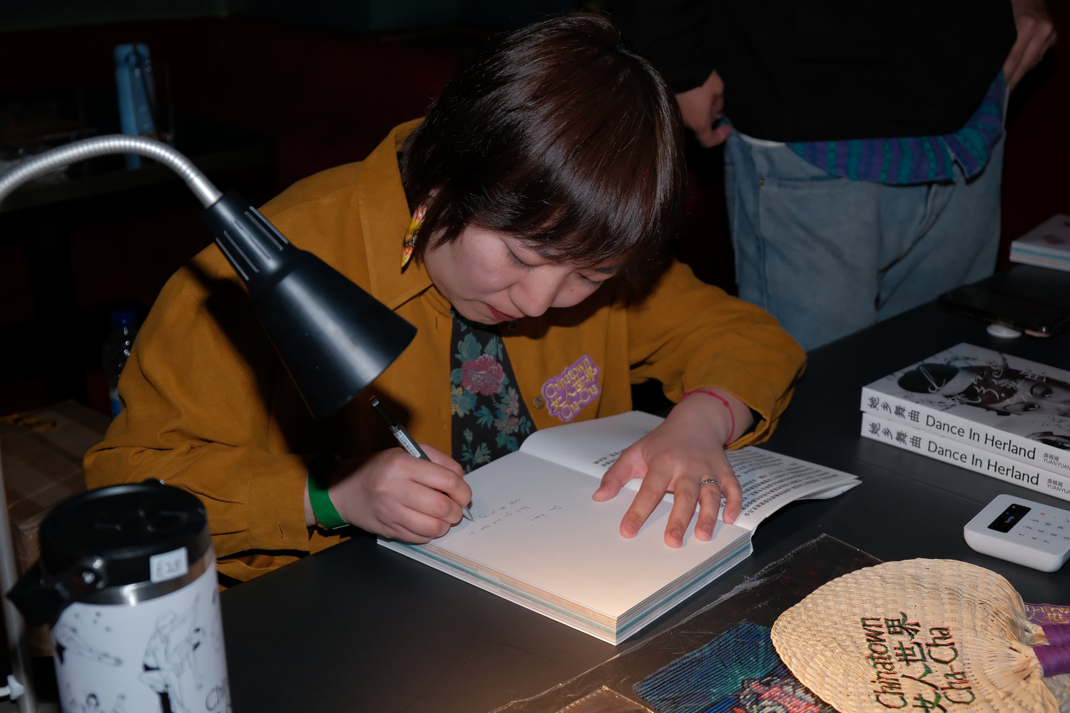 Director Luka Yuanyuan Yang signing her book. Credit, Katie Ou.
