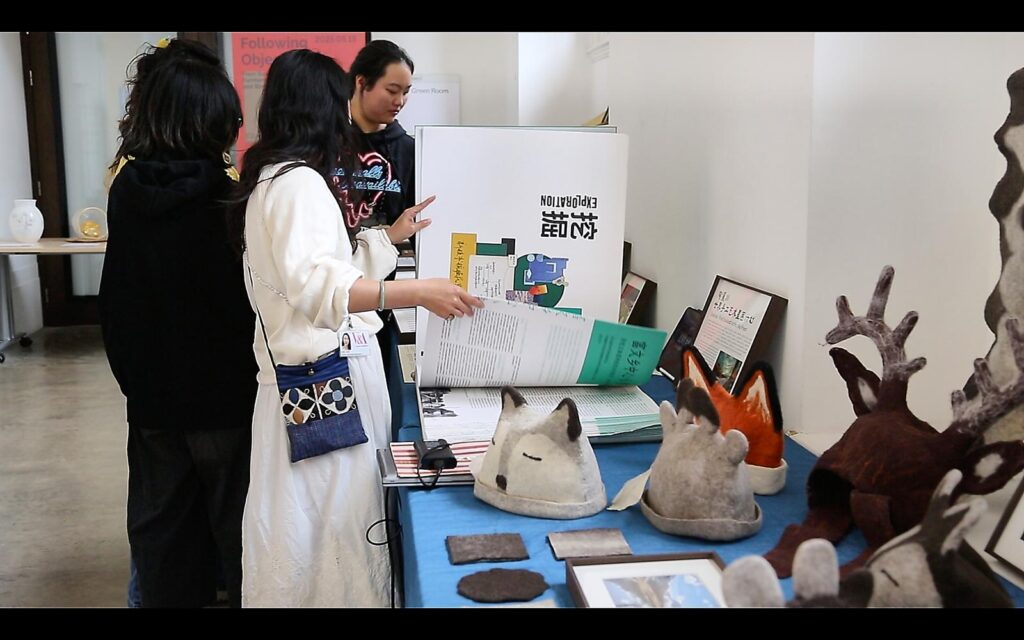 Attendees exploring displays as part of the conference. Image by Li Kuo.