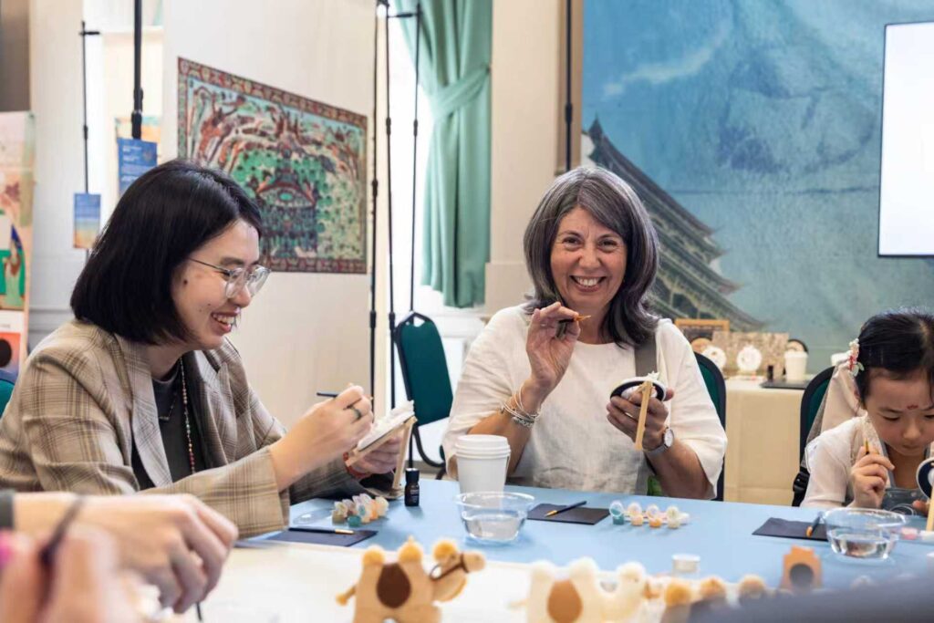 Visitors try out hands on crafts to learn more about Dunhuang culture. Image from organisers.