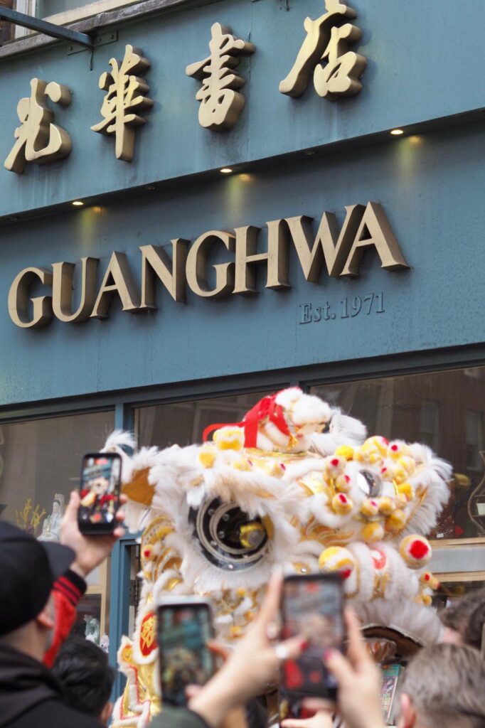 A lion dance performance in front of Guanghwa bookshop in Chinatown.